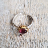 Ring with a pink tourmaline cabochon made with 925 silver and 22 kt gold